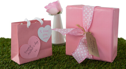 Happy mothers day gifts with rose on grass