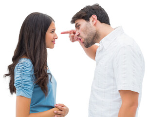 Angry man shouting at upset girlfriend