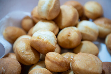 Frying homemade donuts in the kitchen, sweet dessert.
