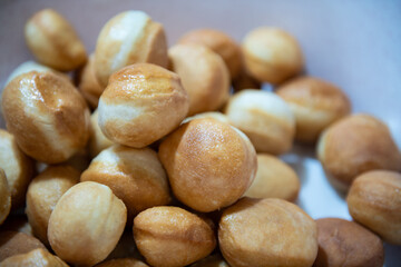 Frying homemade donuts in the kitchen, sweet dessert.