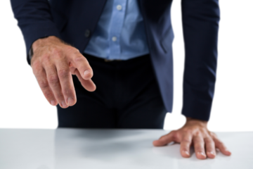 Businessman touching invisible screen on wooden table