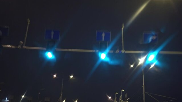 Bottom view of the blurry lights of the streetlights at night