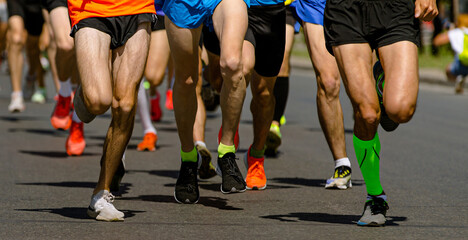 close-up legs runners running sport marathon, male jogging race in asphalt road, athletics...