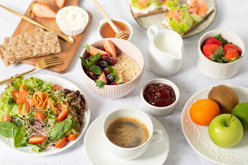 Healthy breakfast set on grey background. The concept of delicious and healthy food. Top view, copy space.