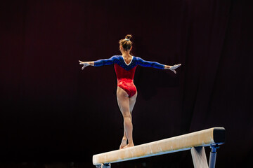 back female gymnast athlete balancing on balance beam gymnastics, sports summer games - obrazy, fototapety, plakaty
