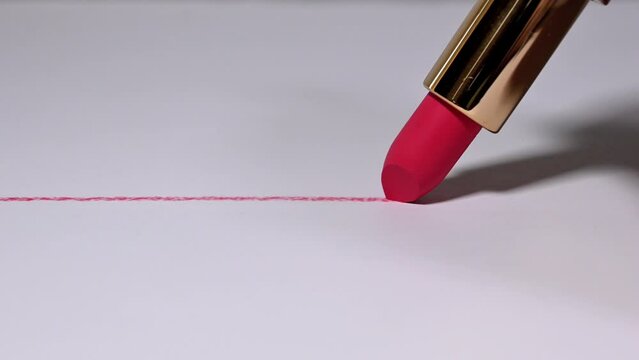 red lipstick on paper drawing a straight line