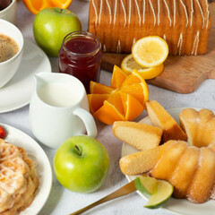 table with cupcakes, coffee, sweet pastries and fruits, buffet concept