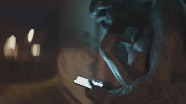 Thinker statue holding a smartphone. 3D animation of Auguste Rodin 100 year old sculpture.