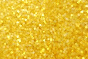 Golden defocused glitter texture as background
