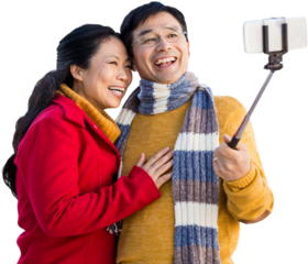 Older asian couple on balcony taking selfie
