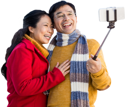 Older asian couple on balcony taking selfie