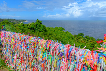 Colored ribbons tied to a fence, souvenir and tradition of those who visit Porto Seguro - Bahia,...