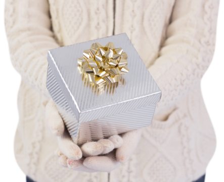 Festive brunette holding a gift - Powered by Adobe