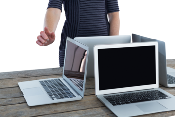Mid section of businesswoman using interface by laptop computers on table