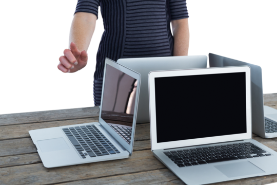 Mid section of businesswoman using interface by laptop computers on table