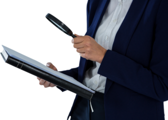 Businesswoman looking at document through magnifying glass