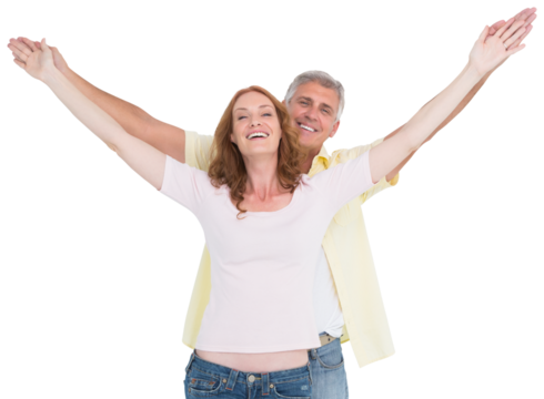 Casual couple smiling with arms raised