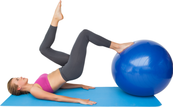 Side view of a fit woman exercising with fitness ball