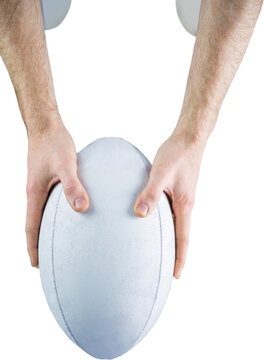 A rugby player posing a rugby ball