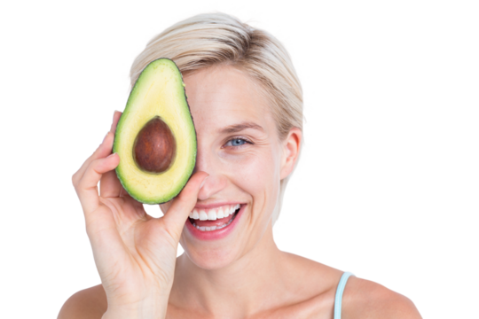 Pretty woman covering her eye with an avocado - Powered by Adobe