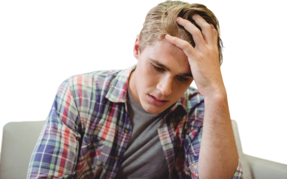 Businessman with head in hands sitting against white background