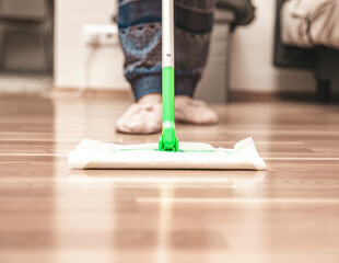 Woman cleaning floor using mop at home, swob, house work, closeup