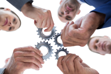 Business colleagues holding cogs
