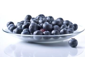 Closeup of fresh juicy blueberries on transtparent glass plate isolated on white background, copy space. High resolution. Generative AI