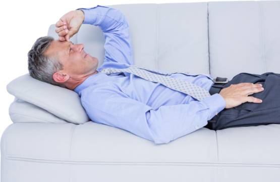 Businessman suffering from headache while lying on sofa - Powered by Adobe