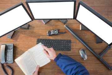 Security officer reading novel at desk