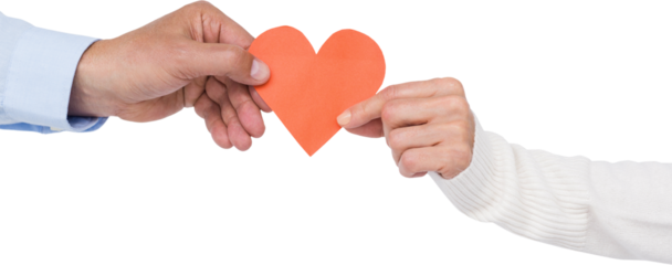 Couple holding paper heart shape paper
