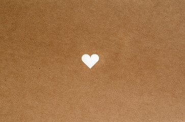 Obraz premium small cute heart on brown craft paper background