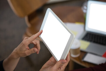 Cropped hands of businesswoman using tablet computer 