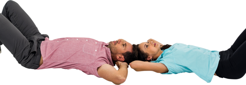 Peaceful young couple laying on floor with hands on their heads