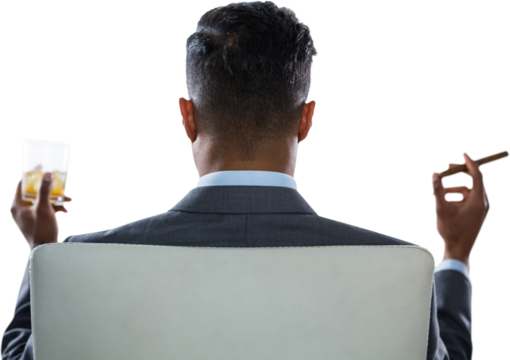 Rear view of businessman holding whisky glass and cigar - Powered by Adobe