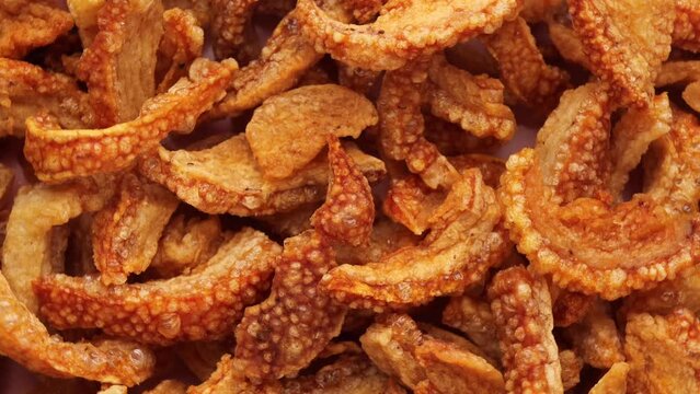 pork skins, rotation in circle. Chicharon Turning. selective focus.
