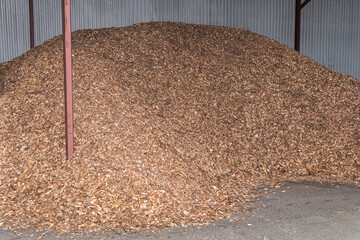Sawdust pile, bunch of wood pieces, chips outdoors in a warehouse