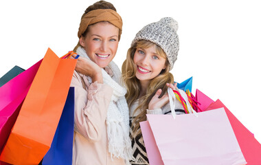 Smiling women looking at camera with shopping bags 