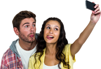 Couple sticking out tongue while taking selfie 
