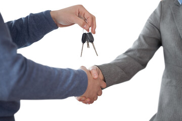 Corporate man shaking hands and giving keys