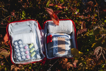 Open first-aid kit with medicines, first aid kit, a set of tablets, bandages for dressing, compact...