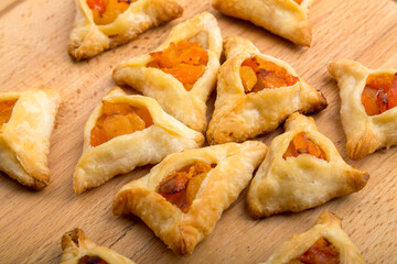 Triangular gomentashi cookies for the holiday of Purim laid out on a napkin.