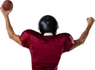 Rear view of American football player holding ball