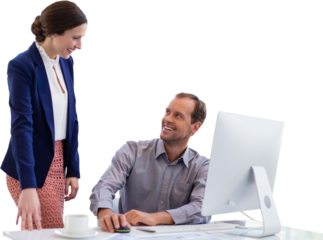 Businesswoman talking to colleague sitting at desk against white background