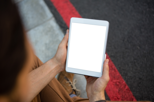 Cropped hands of man holding tablet - Powered by Adobe