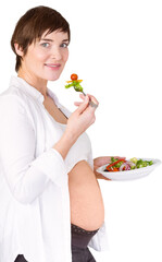 Portrait of smiling pregnant woman eating salad