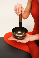 Nepal Buddha copper black singing bowl. Close up in the white studio. Sound therapy, recreation, meditation, healthy lifestyle.