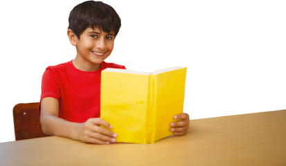 Portrait of boy reading book in library