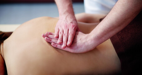 Woman Receiving Back Massage From Therapist
