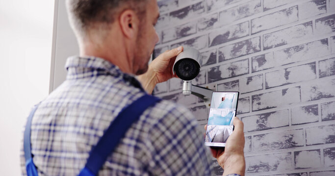 Technician Adjusting CCTV